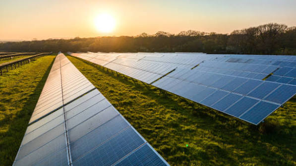 Aerial view of a solar farm in the New England countryside at sunrise